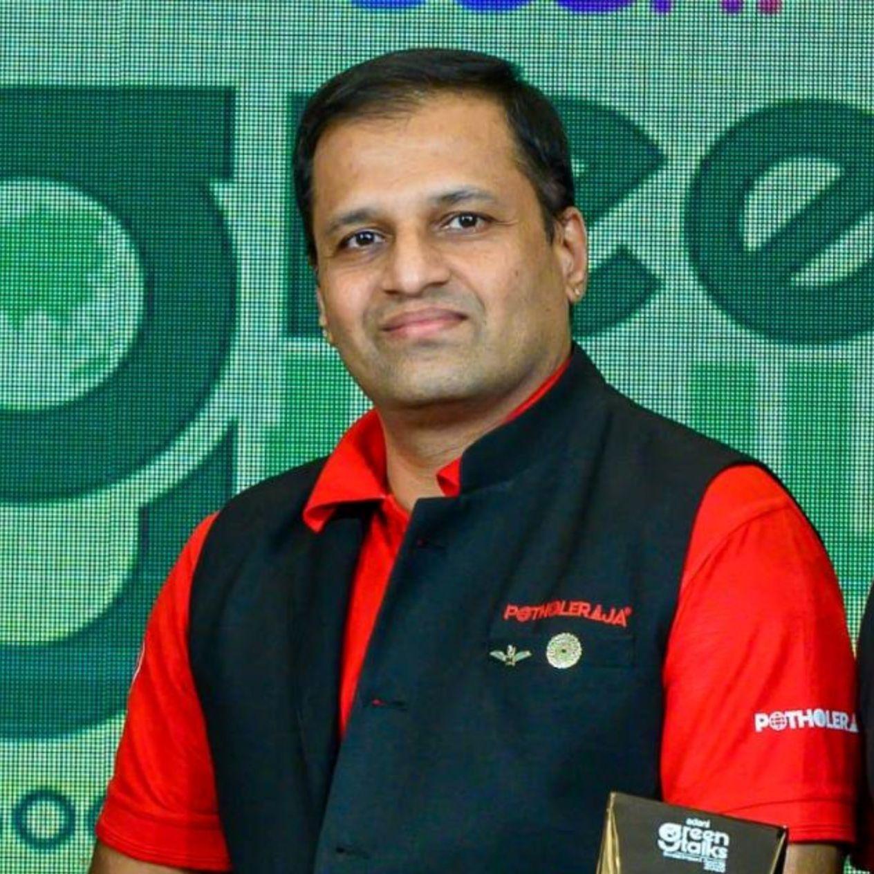 Dr Prathap B holding the Adani Green Talks award