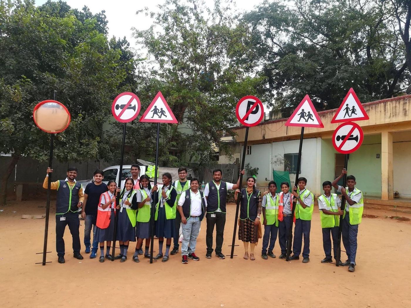 Volunteers holding road safety signboards